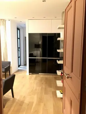 a living room with a wooden floor and a door at Appartements Urban et Pure in Cannes