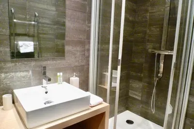 a bathroom with a sink and a shower at Appartements Urban et Pure in Cannes
