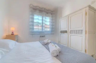a bedroom with a bed with towels on it at IMMOGROOM - Appartment - 1min from the beach - Wifi in Cannes