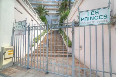 a metal gate with a staircase in front of a building at IMMOGROOM - Appartment - 1min from the beach - Wifi in Cannes