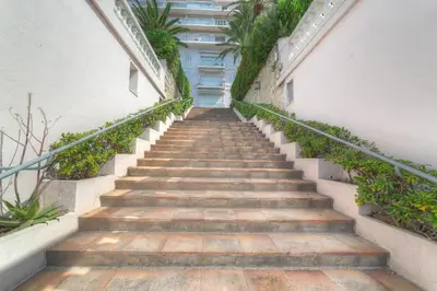 a staircase leading up to a building with plants at IMMOGROOM - Appartment - 1min from the beach - Wifi in Cannes