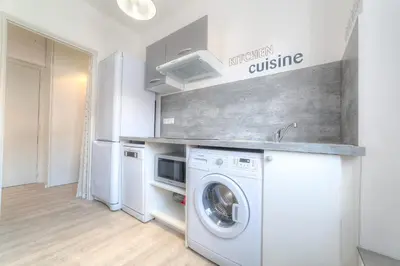 a kitchen with a washer and dryer in a room at IMMOGROOM - Appartment - 1min from the beach - Wifi in Cannes