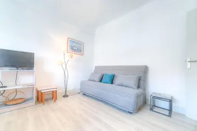 a living room with a couch and a tv at IMMOGROOM - Appartment - 1min from the beach - Wifi in Cannes