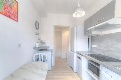 a kitchen with white cabinets and a counter top at IMMOGROOM - Appartment - 1min from the beach - Wifi in Cannes