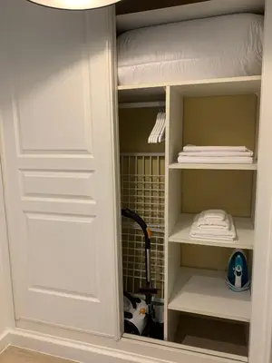 a closet with a white door and some towels at Cannes Pool & Beach in Cannes