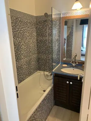 a bathroom with a bath tub and a sink at Cannes Pool & Beach in Cannes