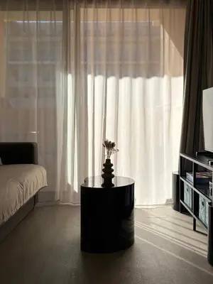 a room with a bed and a table in front of a window at Cannes Pool & Beach in Cannes