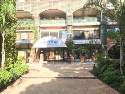 a large building with a sign in front of it at Cannes Pool & Beach in Cannes
