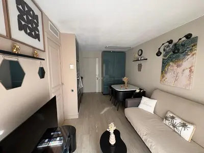 a living room with a couch and a table at Cannes Pool & Beach in Cannes