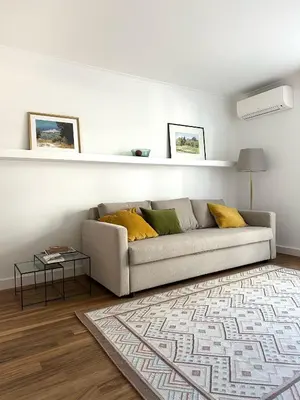 a living room with a couch and a table at Appartement rénové CANNES, palm beach in Cannes