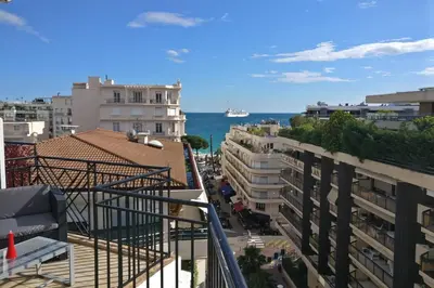 a view of the ocean from the balcony of a building at Nice apartment last floor with terrace and clear view on the sea in Cannes
