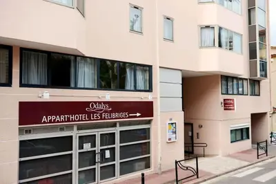an apartment building with a sign that reads apartment hotel his business at Vacances Cannoise, mer et piscine in Cannes