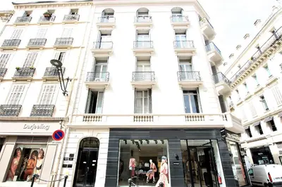 a white building with a store in front of it at RUE D'ANTIBES CENTER in Cannes