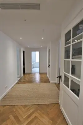 an empty living room with white walls and wood floors at RUE D'ANTIBES CENTER in Cannes