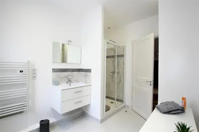 a white bathroom with a sink and a shower at RUE D'ANTIBES CENTER in Cannes