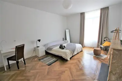 a bedroom with a bed and a desk and a chair at RUE D'ANTIBES CENTER in Cannes