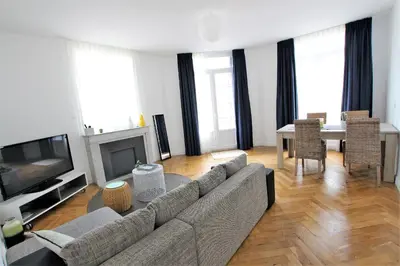 a living room with a couch and a television and a table at RUE D'ANTIBES CENTER in Cannes