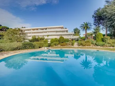 a swimming pool in front of a building at Apartment Les Hortensias by Interhome in Cannes