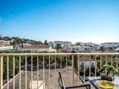 a balcony with a table and chairs and a view of the city at Studio le Tivoli by Interhome in Cannes