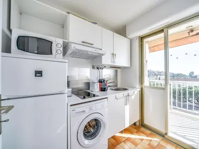 a kitchen with a washer and dryer and a window at Studio le Tivoli by Interhome in Cannes
