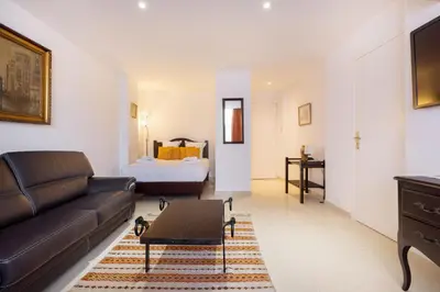 a living room with a couch and a bed at Agence des Résidences - Appartements privés du 45 CROISETTE - Standard in Cannes