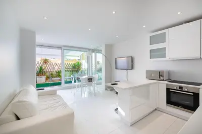 a white living room with a couch and a table at Agence des Résidences - Appartements privés du 45 CROISETTE - Standard in Cannes