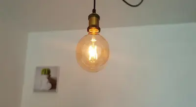 a glass light bulb hanging from a ceiling at Sea view La Palme d'Azur apartment steps away from the beach and perfect for holidays & business trips in Cannes