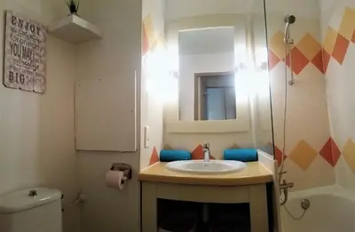 a bathroom with a sink and a mirror and a toilet at Sea view La Palme d'Azur apartment steps away from the beach and perfect for holidays & business trips in Cannes