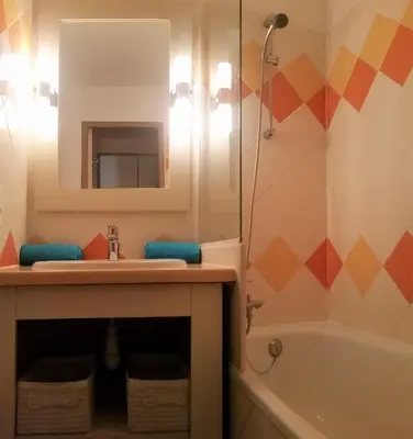 a bathroom with a sink and a mirror and a tub at Sea view La Palme d'Azur apartment steps away from the beach and perfect for holidays & business trips in Cannes