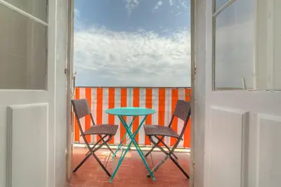 a table and chairs on a balcony with a view at IMMOGROOM - Studio - Sea view next to the Palais - CONGRESSBEACHES in Cannes