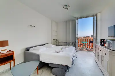 a bedroom with a bed and a balcony at IMMOGROOM - Studio - Sea view next to the Palais - CONGRESSBEACHES in Cannes