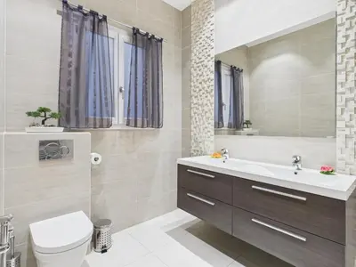a bathroom with a sink and a toilet and a mirror at Residence du Louvre - Apartments - Prime location Palais & Croisette - Luxury Stay by LRA Cannes in Cannes