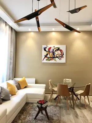 a living room with a white couch and a table at NUMA BLANC 300 M PALAIS DES FESTIVALS in Cannes