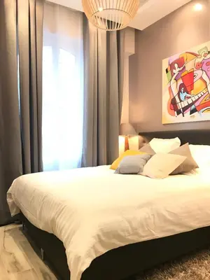 a bedroom with a large bed and a window at NUMA BLANC 300 M PALAIS DES FESTIVALS in Cannes