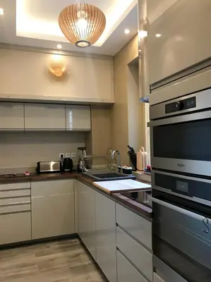a kitchen with white cabinets and stainless steel appliances at NUMA BLANC 300 M PALAIS DES FESTIVALS in Cannes