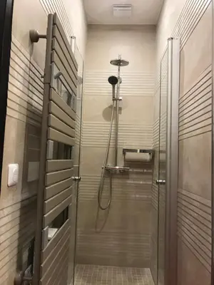 a shower with a glass door in a bathroom at NUMA BLANC 300 M PALAIS DES FESTIVALS in Cannes
