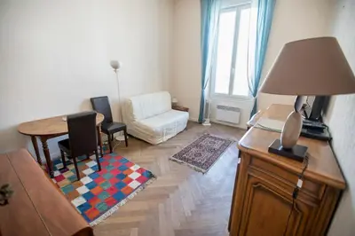 a living room with a couch and a table with a lamp at Bohemian Apartment by Connexion in Cannes
