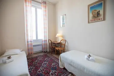 a bathroom with a washing machine and a sink at Bohemian Apartment by Connexion in Cannes
