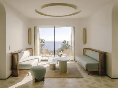 a living room with a view of the ocean at Hôtel & Spa Belle Plage in Cannes