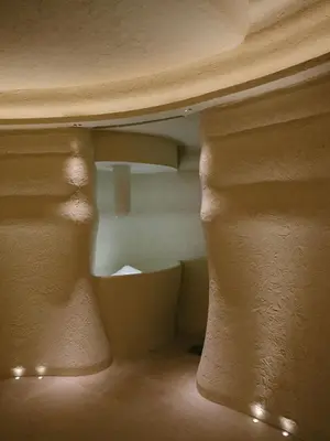 a room with a table and a room with a tub at Hôtel & Spa Belle Plage in Cannes