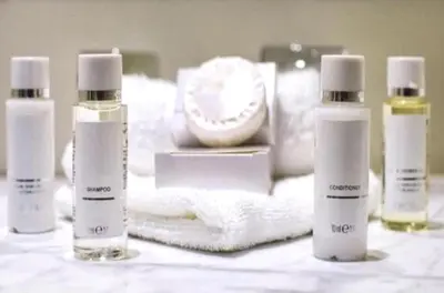 a group of three bottles of hair products on a table at PALAIS MIRAMAR CROISETTE APART 1 MIN CARLTON in Cannes