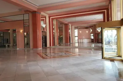 an empty lobby with glass doors and a tile floor at PALAIS MIRAMAR CROISETTE APART 1 MIN CARLTON in Cannes