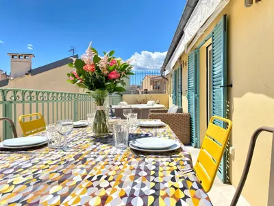 a table with a vase of flowers on a balcony at Luxury 