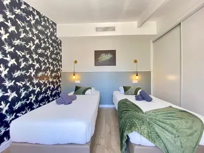 two beds in a room with a wall mural at Luxury 