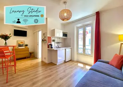 a living room and kitchen with a couch and a table at Studio Luxury Toîts du Soleil By SCLS Locations in Cannes