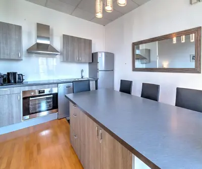 a kitchen with a large counter top in a room at IMMOGROOM - Charming apartment - City Center - Wifi - AC in Cannes