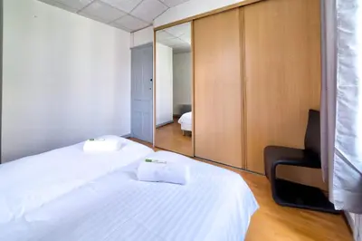 a hotel room with two beds and a mirror at IMMOGROOM - Charming apartment - City Center - Wifi - AC in Cannes