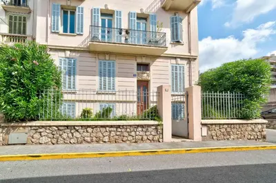 a building with a fence in front of it at IMMOGROOM - Charming apartment - City Center - Wifi - AC in Cannes