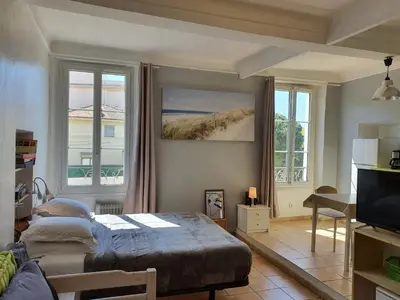 a bedroom with a bed and a large window at Saint Dizier in Cannes