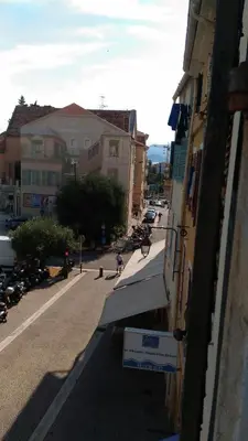 a view of a street with buildings and a person riding a bike at Saint Dizier in Cannes